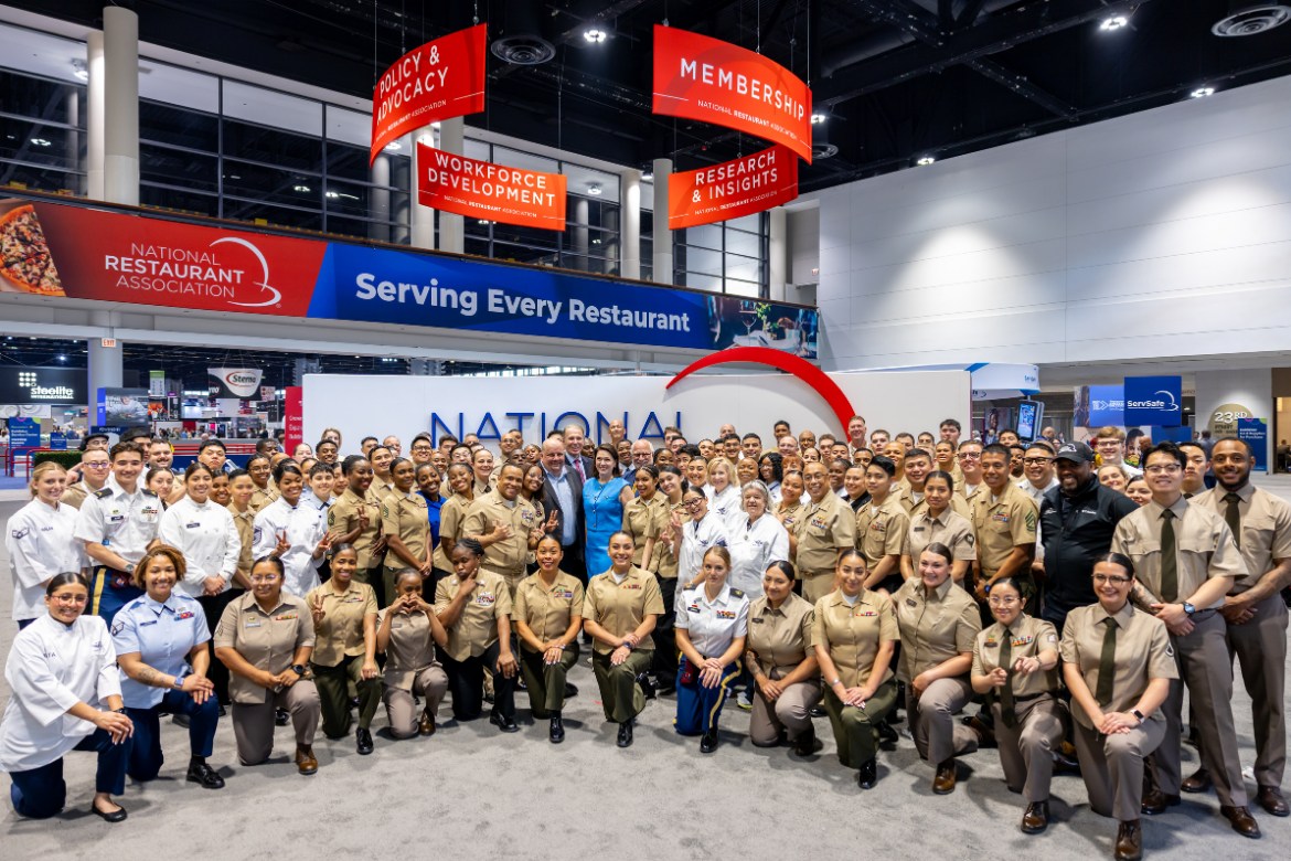 Members of the Military Foodservice training, posing at the National Restaurant Association booth at the NRA Show