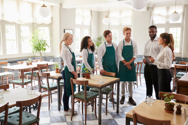 Photo of restaurant workers talking with a manager
